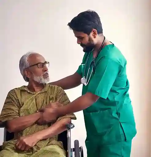 Male caregiver assisting senior man in wheelchair – home health care services in Chennai