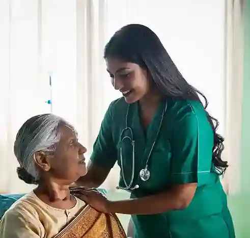 Female caregiver attending to elderly woman at home – home health care services in Chennai